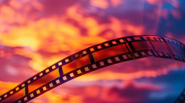 A film strip with a sunset background photo