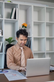 Business professional working on laptop in modern office environment business strategy indoor setting focused view photo