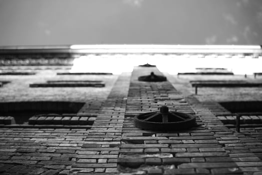 Upward view on facade of old factory building, black and white image photo