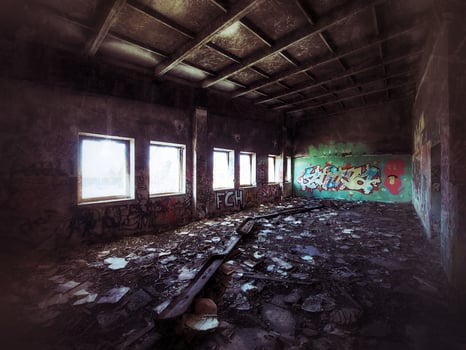 Grungy shot of ruined factory room full of trash photo