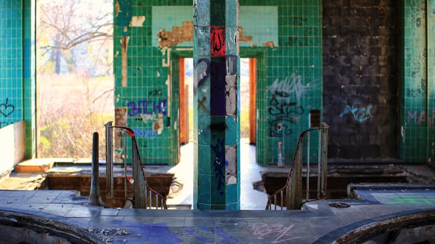 Railing and tiled pillar in a long abandoned brewery in Germany photo