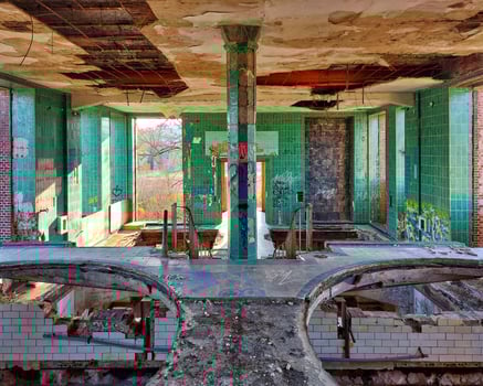 Hall with railing and tiled pillar in a long abandoned brewery in Germany photo