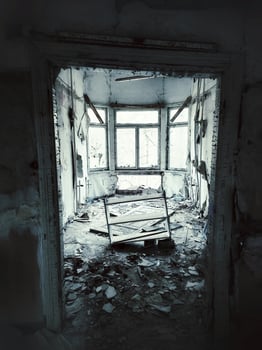 Grungy shot of ruined gazebo with leaning door and shelf photo