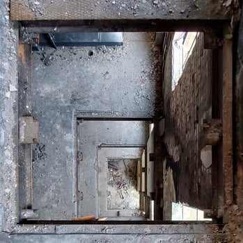 Looking downward through several floors of a ruined building photo