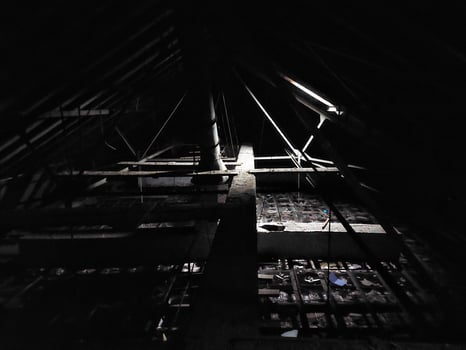 Dark and creepy attic with little daylight photo