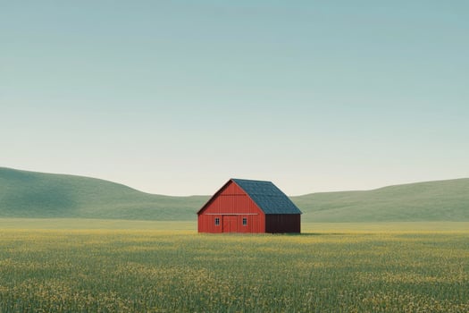 A red barn in a field with hills in the background photo