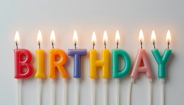 Celebration Embers Row of Luminous Birthday Candles on Pristine White photo