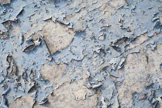 Peeling paint on the wall. a concrete wall with old cracked flaking paint photo