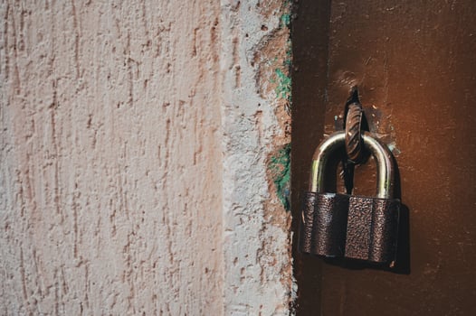 a lock hanging on an old door photo