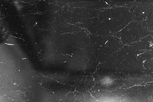 Black marble surface with subtle textures and reflections under lighting photo