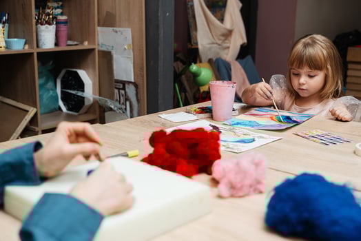 A child engaged in creative painting activity in a cozy art studio photo