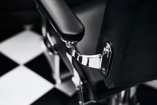 Modern barber chair detail in stylish black and white barbershop interior photo
