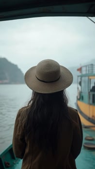 Woman enjoying a peaceful boat ride surrounded by nature on a sunny day photo
