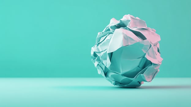 Crumpled Paper Ball in aqua blue background bright tone photo