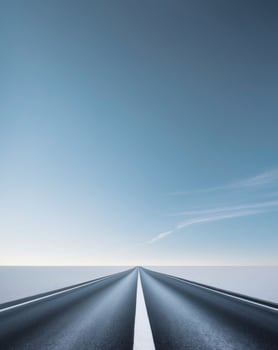 A long road with a white line and a cloudless sky photo