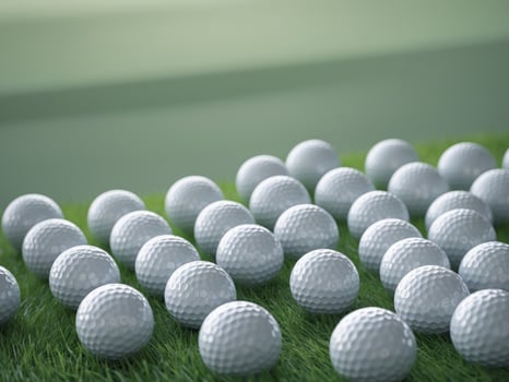 Blank golf balls arranged on a green field for branding or design purposes photo
