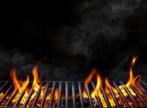 A grill with flames and smoke on it photo