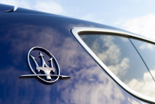 Poznan, Poland. 20 December, 2024 Maserati logo on blue luxury car exterior photo