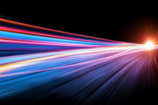 Abstract light trails in vibrant colors against a black background. photo
