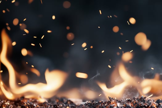 Flames and sparks rising against a dark background, evoking warmth and intensity. photo
