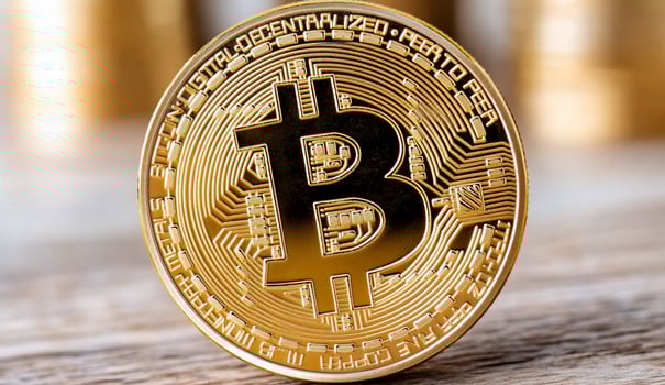 A close-up of a gold Bitcoin symbolizing cryptocurrency investment. photo