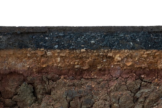 The layer of asphalt with soil and rock. Un-focus image. photo
