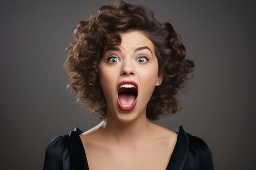 Surprised woman with curly hair making an exaggerated facial expression photo