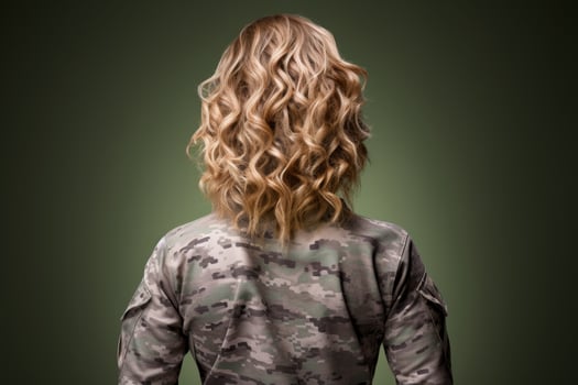 Curly blonde hair of a person in military uniform photo
