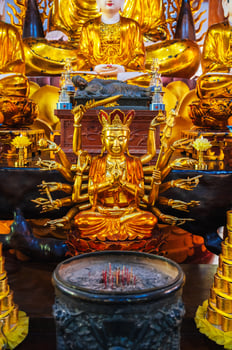 golden Shiva figurine on an altar inside a Buddhist temple photo