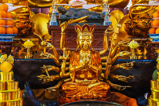 golden Shiva figurine on an altar inside a Buddhist temple photo