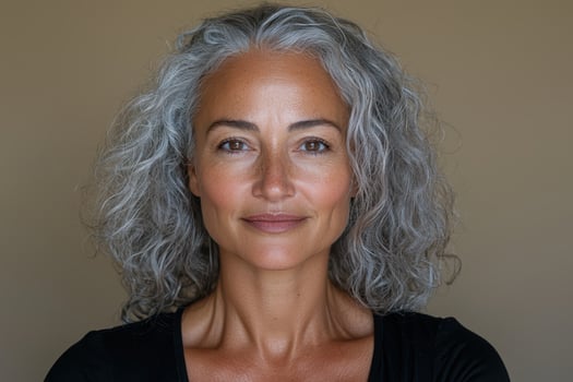 Portrait of a beautiful mature woman with gray curly hair photo