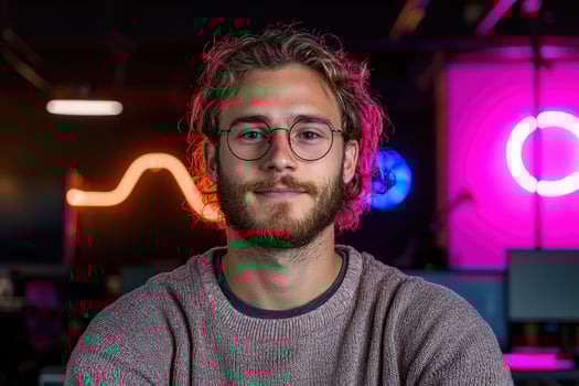 Portrait of a young man with glasses in a modern office photo