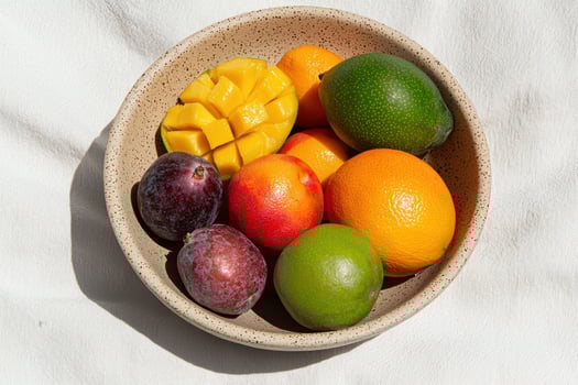 Fresh fruit in a bowl on a white background photo