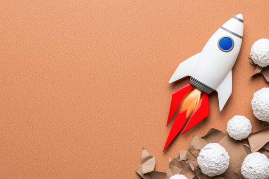 Rocket launching through crumpled paper, business startup concept photo