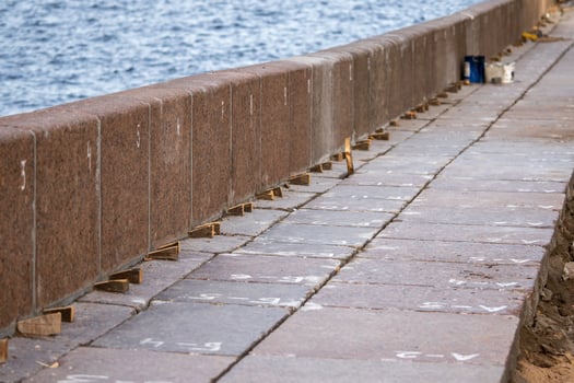 Embankment repair of river strengthens and aligns granite slabs. Granite support on waterfront photo