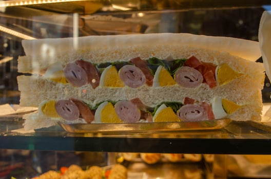 Layered Sandwich with Ham, Eggs, and Fresh Vegetables photo