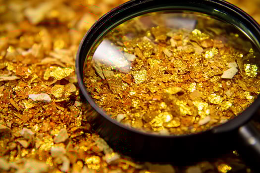 Gold nuggets in a magnifying glass photo