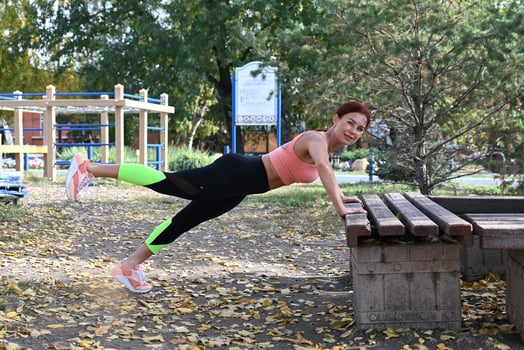 A picture of a woman wearing exercise clothing in a park photo