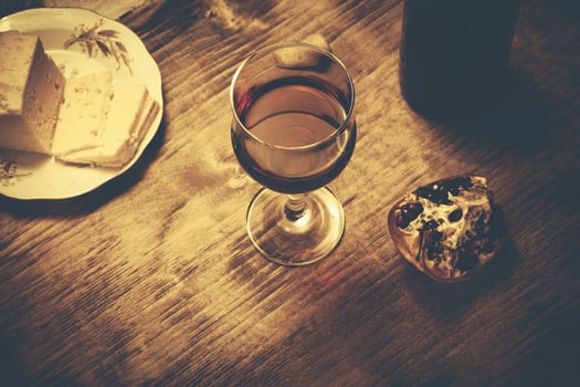 wine glass with cheese and pomegranate photo