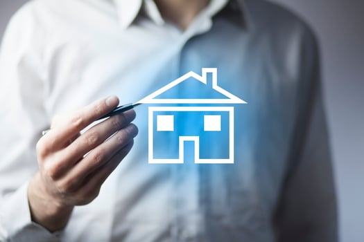 man hand pen with house in screen photo