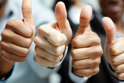 Business people showing thumbs up photo