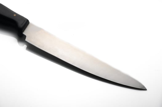 Sharp stainless steel chef knife gleaming with precision in bright light photo