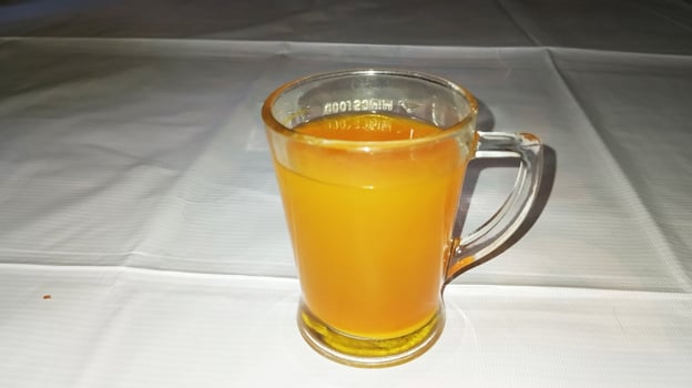 Warm turmeric tea in a glass cup - Semarang, December 27, 2024. photo
