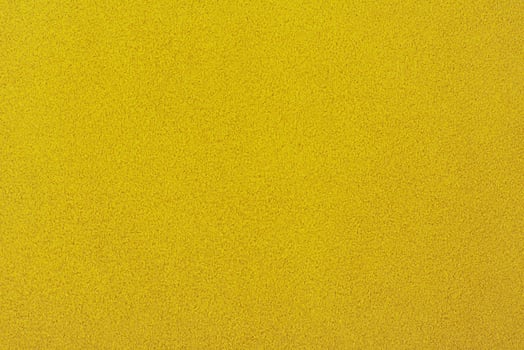 Yellow suede background. Texture of suede leather dyed in light yellow color. photo
