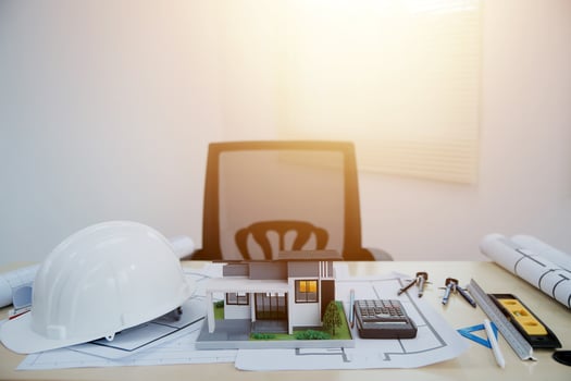 A desk with construction tools and a hard hat photo