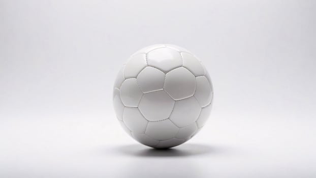A white soccer ball sits on a white background. photo