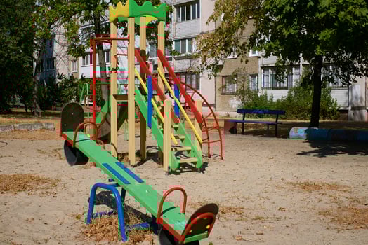 Summer spring children's playground with painted toy slide in park photo