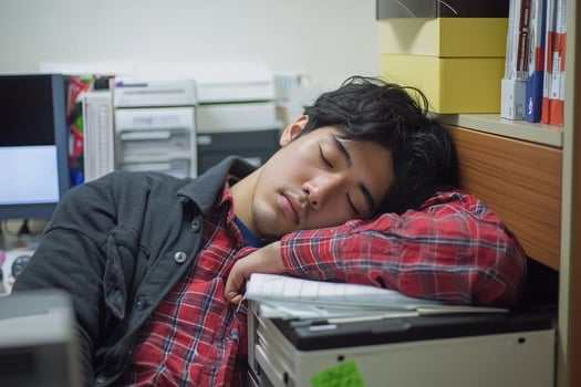 A man sleeping in an office photo