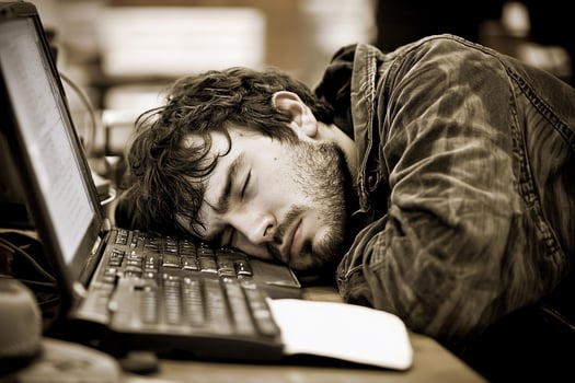 A man sleeping on a desk photo