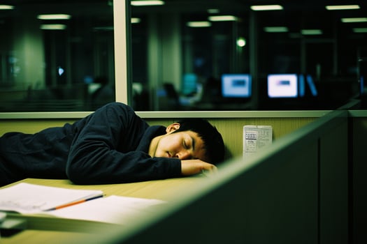 A man sleeping on a desk photo